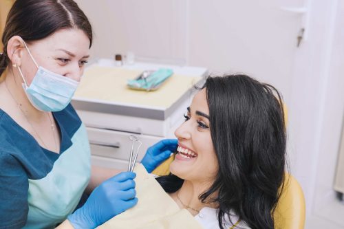 dentist-sitting-near-female-patient